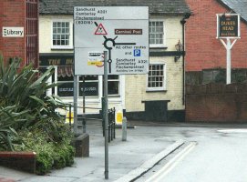 Bus stop in front of sign